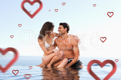 Composite image of couple sitting on pool edge together