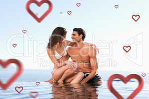 Composite image of couple sitting on pool edge together