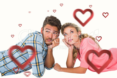 Composite image of attractive young couple lying and thinking