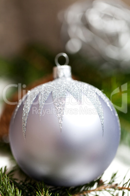 Silver Christmas ornaments in leaves