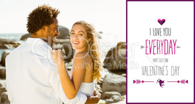 Composite image of gorgeous couple embracing by the coast