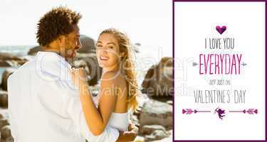 Composite image of gorgeous couple embracing by the coast