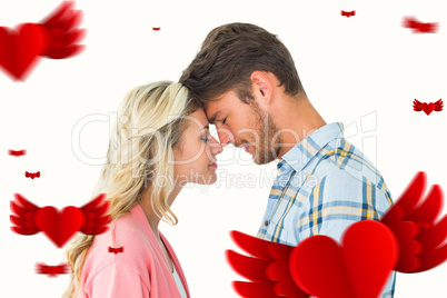 Composite image of attractive couple standing touching heads