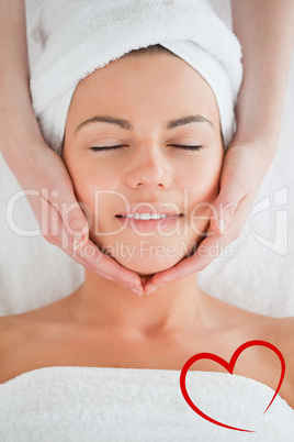 Composite image of portrait of a smiling woman having a facial m