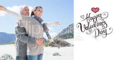 Composite image of carefree couple hugging on the beach in warm