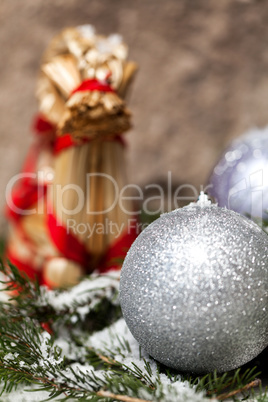 Silver Christmas bauble on a tree with snow