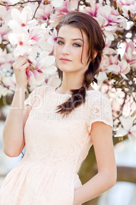 beautiful young woman and pink magnolia