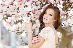 beautiful young woman and pink magnolia