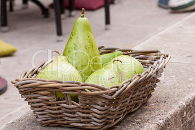 Fresh ripe pears in a wicker basket