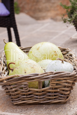 Fresh ripe pears in a wicker basket