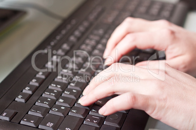 womans hand on a coumputer keyboard