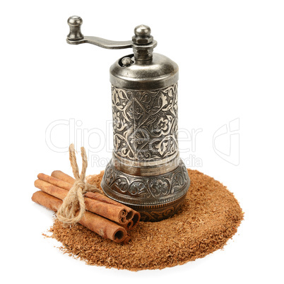 cinnamon and manual grinder isolated on white background