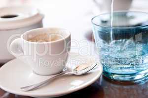 hot aromatic espresso cup and cold water in glass