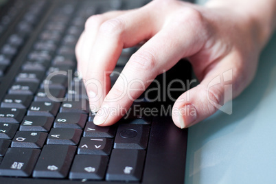 womans hand on a coumputer keyboard