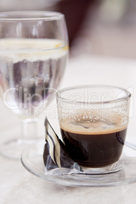 hot aromatic espresso cup and cold water in glass