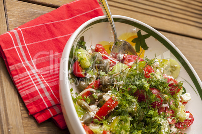 Bowl of Marinated Greek Salad with Red Napkin