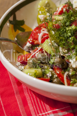 Bowl of Marinated Greek Salad with Red Napkin