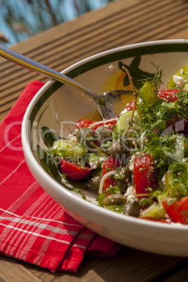 Bowl of Marinated Greek Salad with Red Napkin