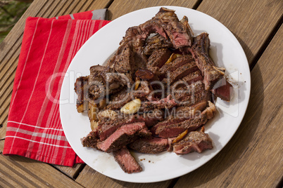 Plate of Grilled Steak and Garlic with Red Napkin