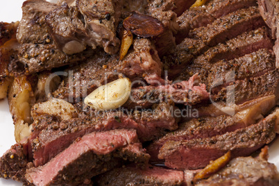 Plate of Grilled Steak and Garlic with Red Napkin