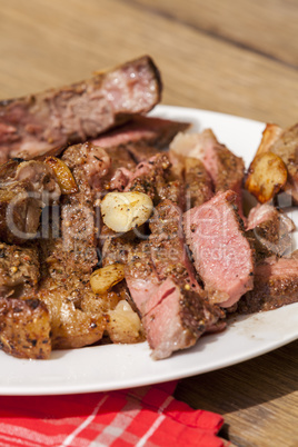 Plate of Grilled Steak and Garlic with Red Napkin