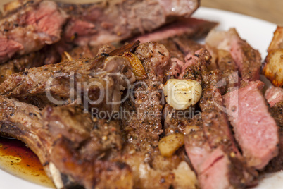 Plate of Grilled Steak and Garlic with Red Napkin