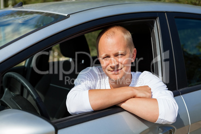 Excited driver holding the keys of his new car