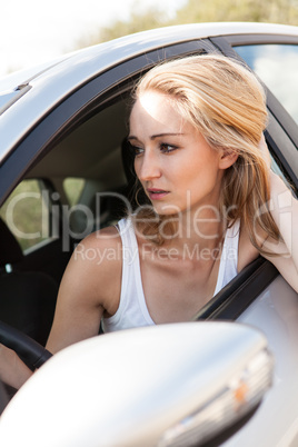 young attractive happy woman sitting in car summertime