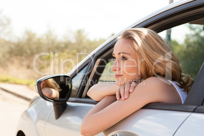 young attractive happy woman sitting in car summertime