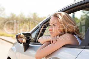 young attractive happy woman sitting in car summertime