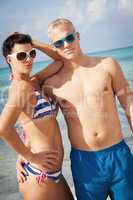 attractive young couple in swimwear and sunglasses