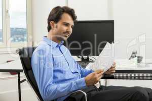 Young man reading written agreements for work