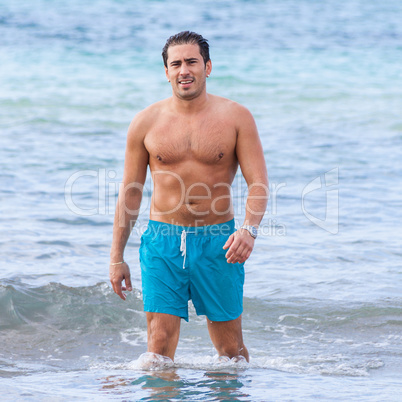 attractive young athletic man on the beach