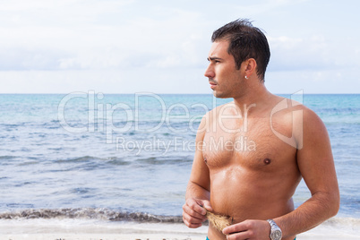 attractive young athletic man on the beach