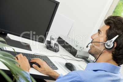 Man wearing headset giving online chat and support