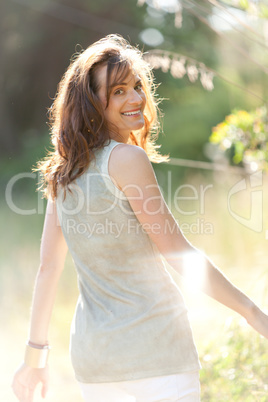 attractive smiling adult woman outside in summer