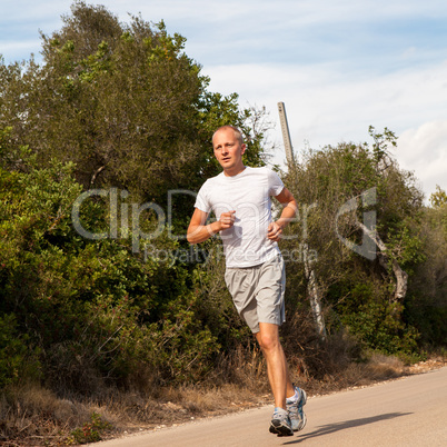 athletic man runner jogging in nature outdoor