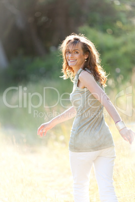 attractive smiling adult woman outside in summer