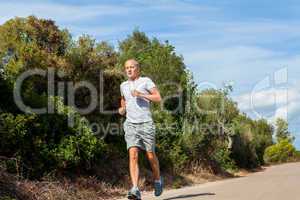 athletic man runner jogging in nature outdoor