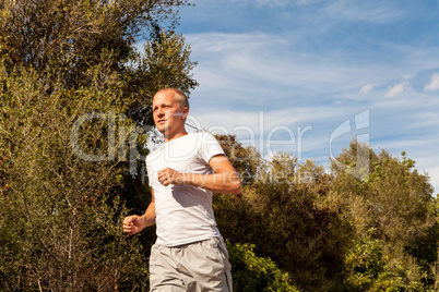 athletic man runner jogging in nature outdoor