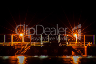 Night scene of a dock or pier with steps