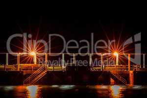 Night scene of a dock or pier with steps