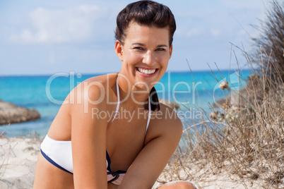 Beautiful young woman in a bikini on the beach