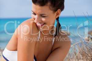 Beautiful young woman in a bikini on the beach
