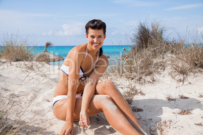 Beautiful young woman in a bikini on the beach