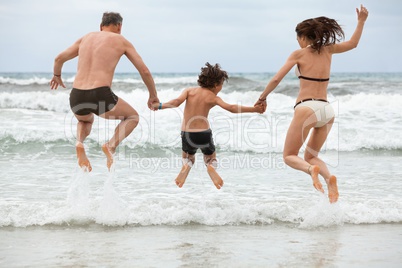 happy family ith two boys having fun in water summer holiday