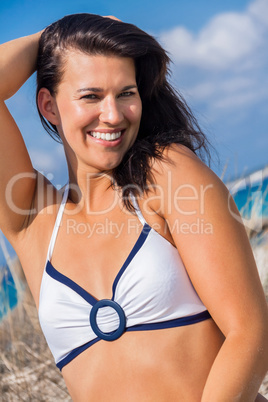 Beautiful woman sitting on golden beach sand