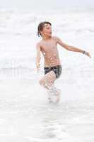 young little boy in water summer holiday fun sea