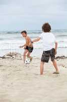 happy family father two kids playing football on beach summer