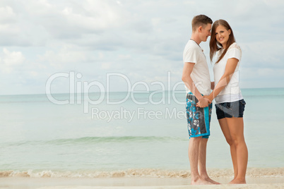 happy young couple on the beach in summer holiday love